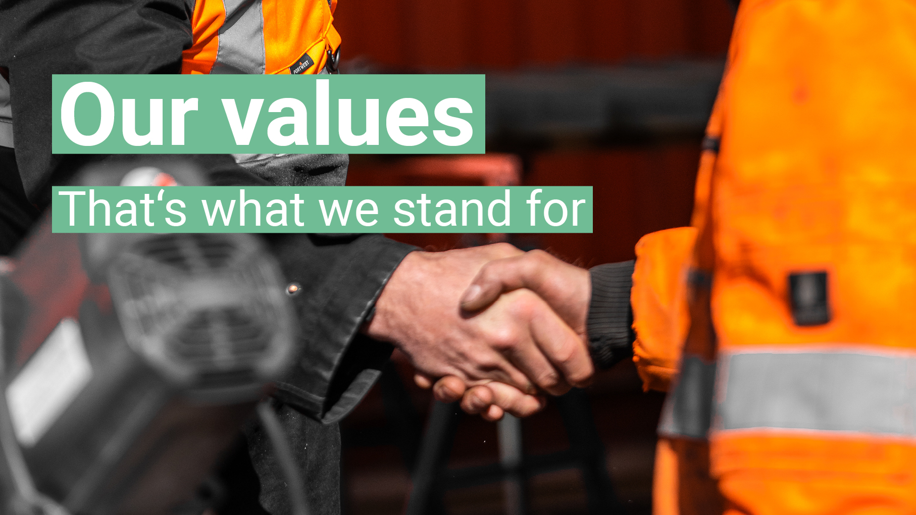 Our values Our values - in the background you can see two people shaking hands.